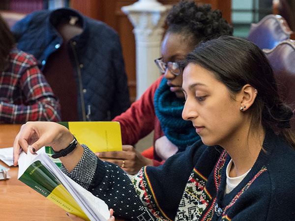 Colgate students read from the epic poem A Book of Satires by Horace during a Classics class.