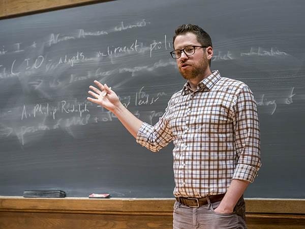 Sam Rosenfeld, Assistant Professor of Political Science, gestures to the blackboard during a session of a class titled Washington and the Shaping of American Politics.