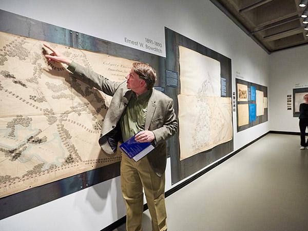 Professor Bob McVaugh points to features on a map during his exhibition on Colgate’s developing campus architecture.