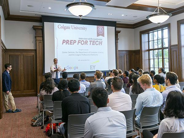 Students observe a presentation at a boot camp for technical interview skills.