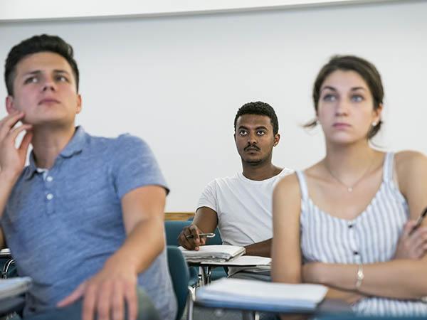 Kelabe Tewolde '18 and two classmates take in a lecture in their political science class.