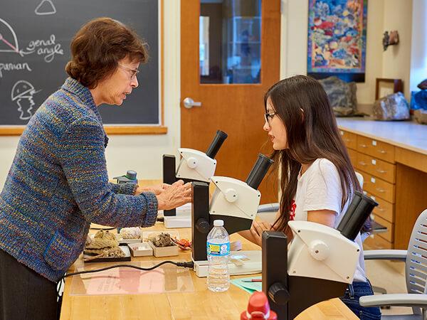 Geology professor Connie Soja works with students in an introductory geology class. 