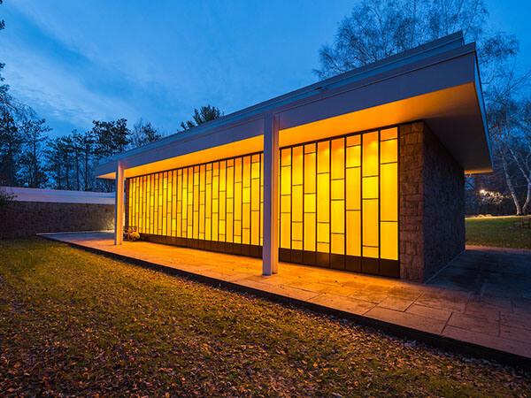 Lighted windows of Colgate’s Chapel House shine in the darkening dusklight