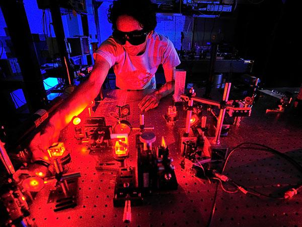  A Colgate University senior conducts experiments using lasers in a laboratory.