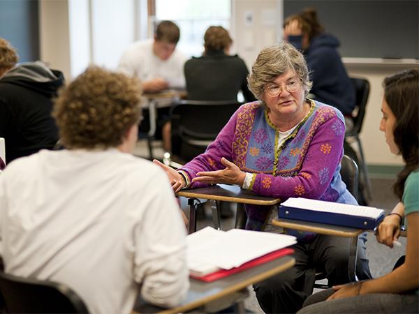Associate Professor Margaret Darby leads a small group discussion during a writing and rhetoric class session