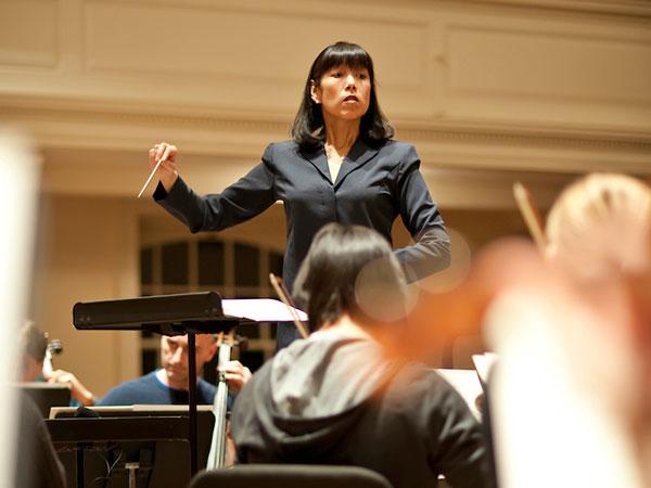 Professor Marietta Cheng conducts the Colgate University Orchestra during a rehearsal.