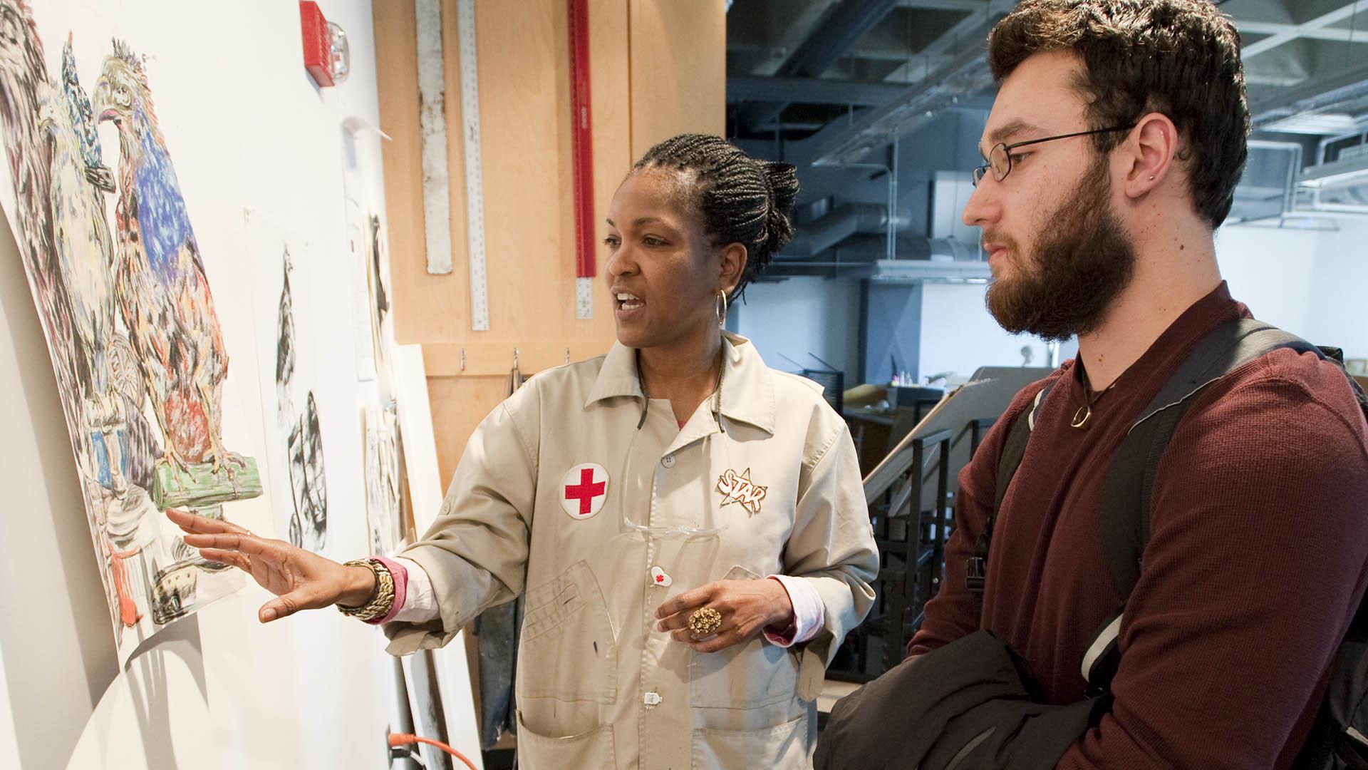 Professor Lynette Stephenson provides feedback to a student on his work.
