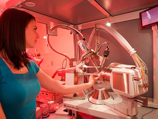 A Colgate chemistry student researcher operates an x-ray diffractometer