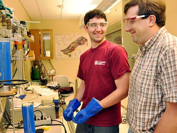 Student performs vacuum extraction with assistance from professor William Peck.