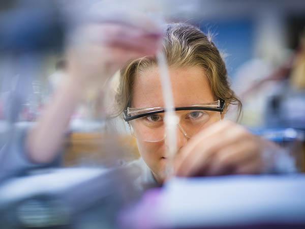 A Colgate biology student focuses on refining her sampling technique.
