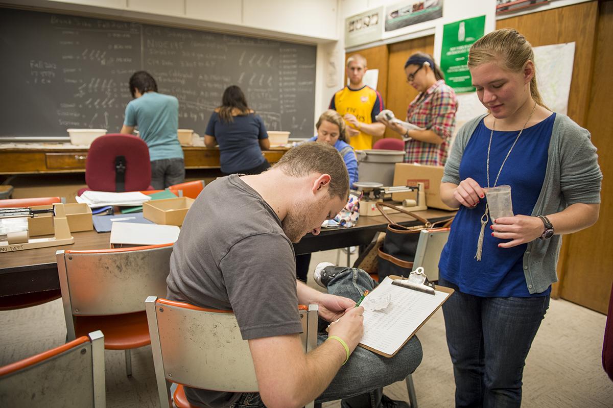 Students discuss and take notes on their findings from the Brunk site in a Field Methods and Interpretation in Archaeology class