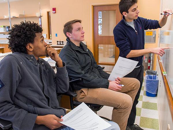 Students in Professor Jeff Bary's class work on solving equations in the laboratory