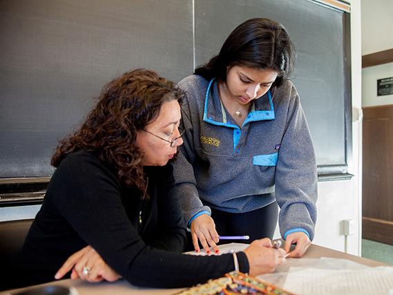 A Colgate student confers with Professor Monica Escudero Moro during an Intermediate Spanish Language & Literature class.