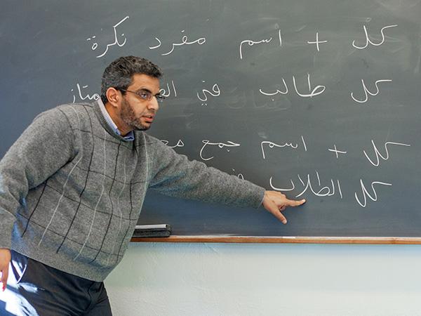 Professor Nady Abdal-Ghaffar gestures at the blackboard while teaching a class on the Arabic language.