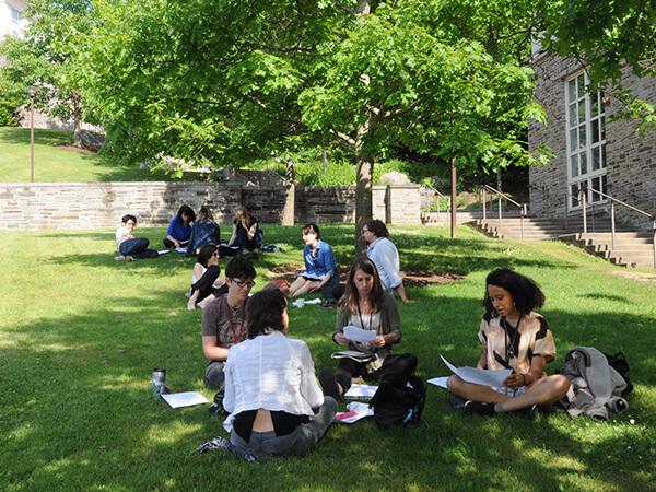 Film and media studies students gather on the grass outside of Little Hall on Colgate’s campus.