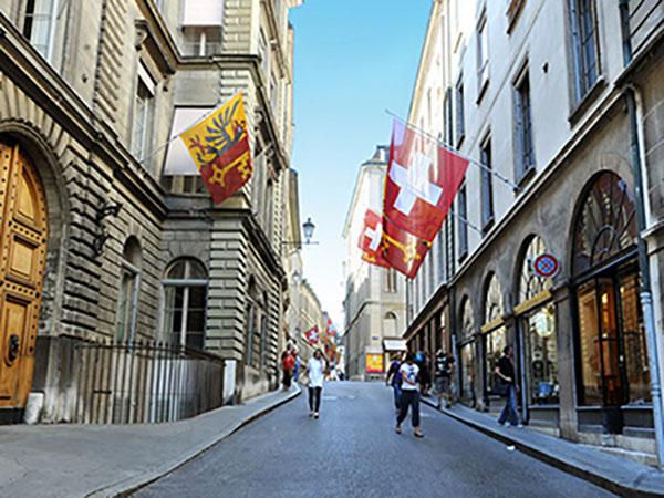 Cobbled street in Geneva with flag.