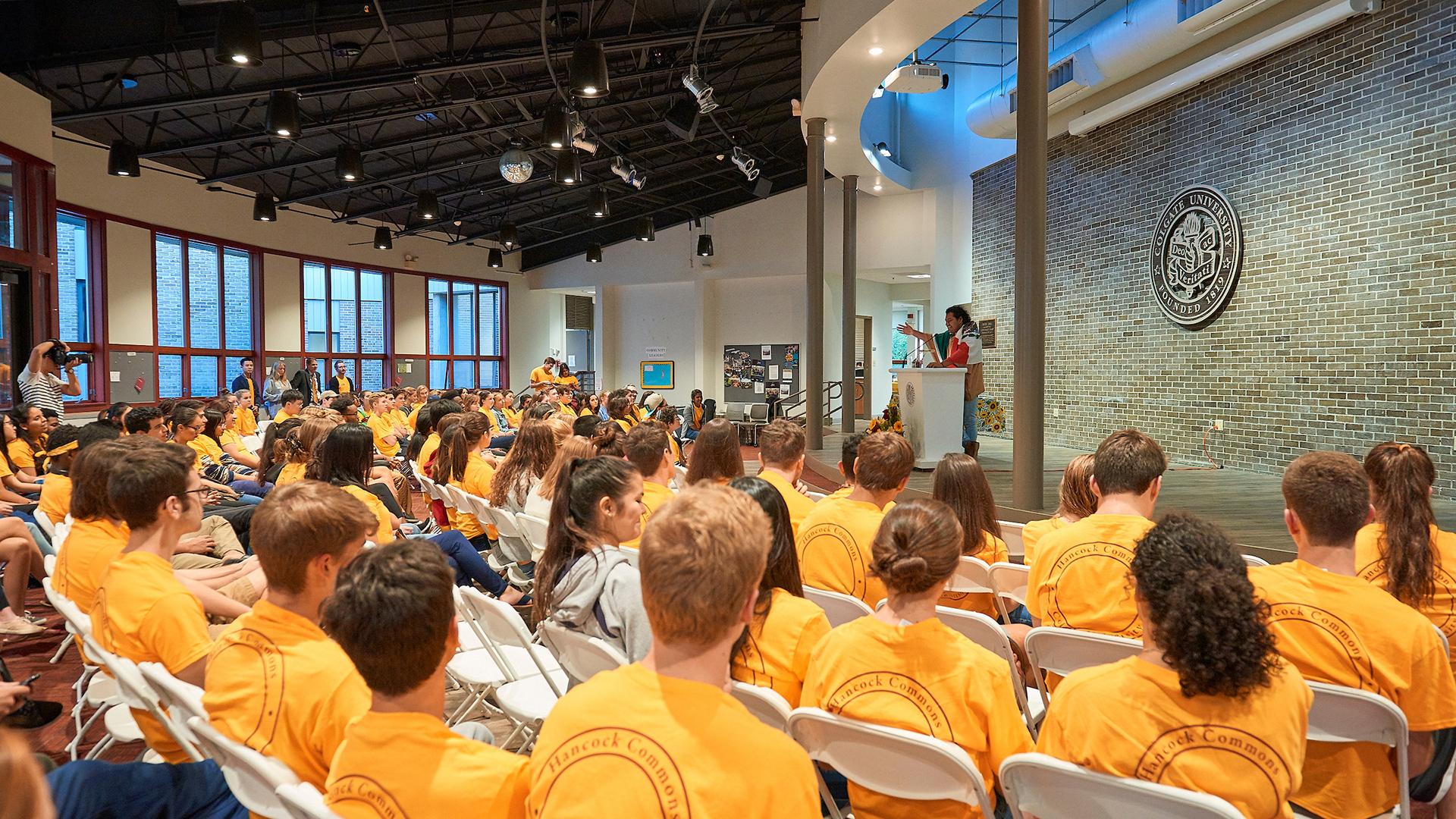 Hancock Commons residents in matching yellow t-shirts gathered in the Edge Café.