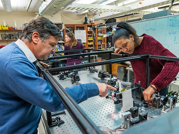 Professor Galvez works with a student in the laser lab