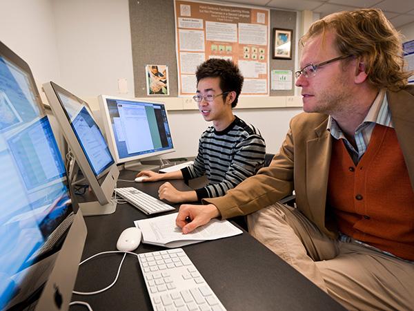 Professor Kelly reviewing digital materials for a personality test with the student
