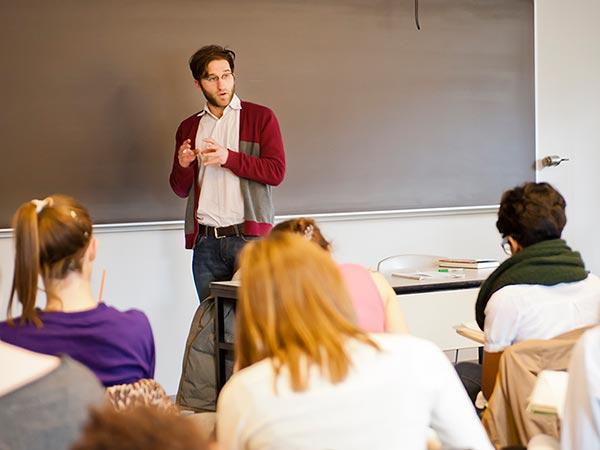 Professor Mark Stern lectures at the blackboard in a classroom
