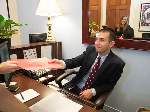 student sitting behind a desk interning with a U.S. Senator