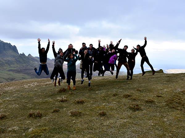 Students jump into air on the hills of Scotland