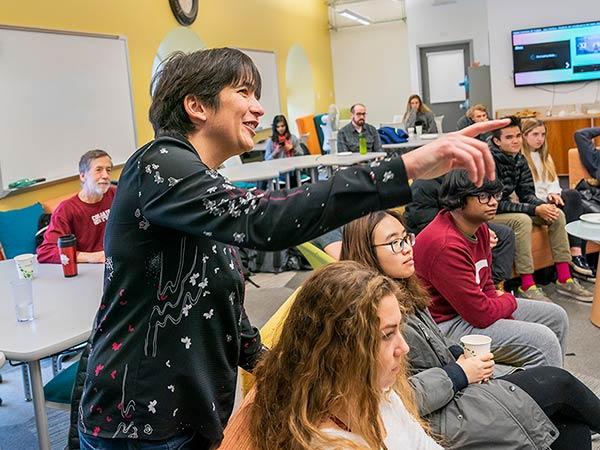 Elodie Fourquet points to something while teaching a computer science class