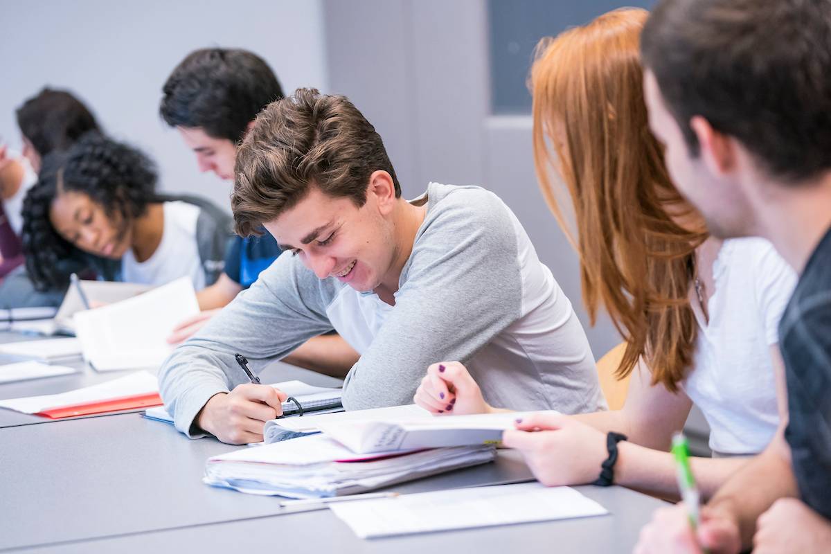 Students with textbooks in a classroom