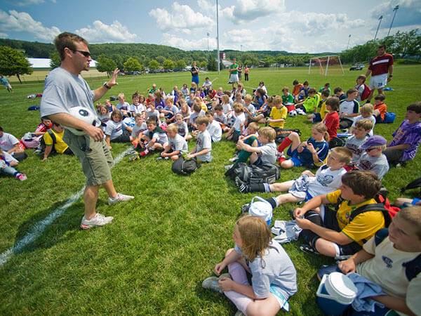 Erik Ronning, head coach of the Colgate men’s soccer program, speaks to participants of a youth soccer camp held on the Colgate campus