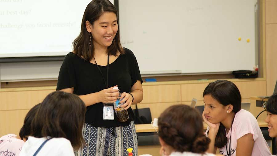 Risako Yang speaks with a group of schoolchildren in Japan