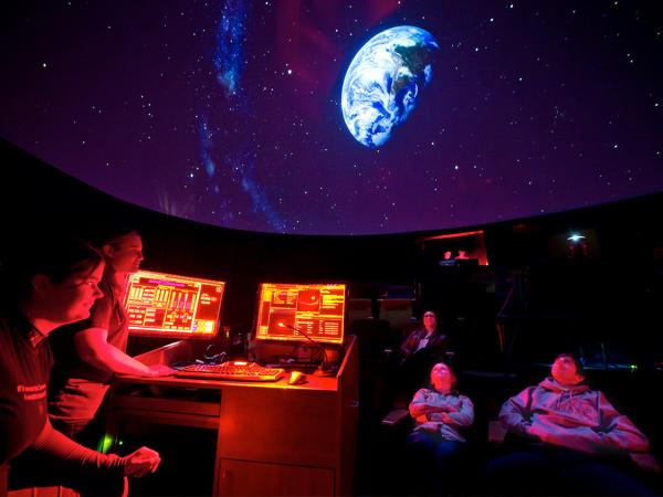 Patrons watch a projection display in the Ho Tung Visualization Laboratory in the Ho Science Center.