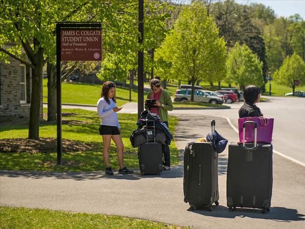 Students wait outside of the Student Union, James C. Colgate Hall, for the bus service to Manhattan.