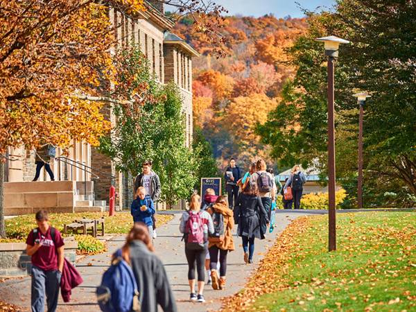 Students walk to class on the academic quad on a beautiful autumn day.