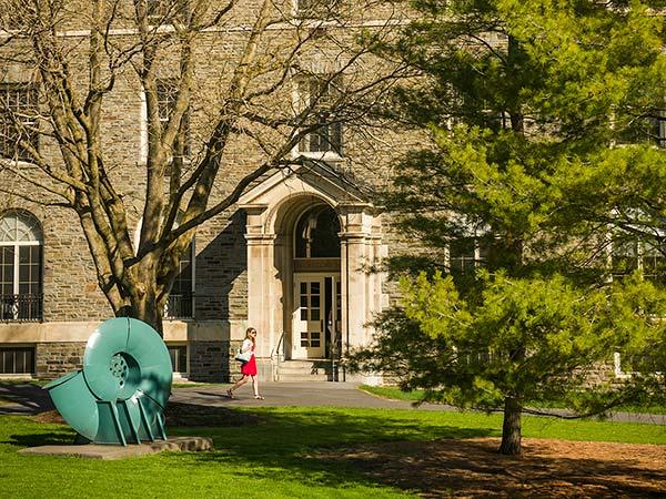 A student walks past the entry of McGregory Hall