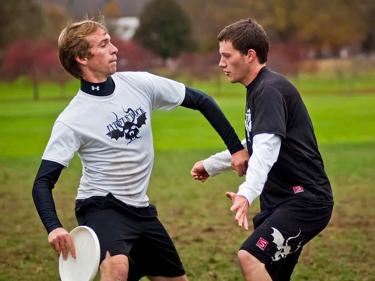 A player prepares to throw the disc during a men's ultimate practice on campus