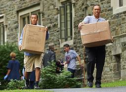 Colgate students hauling boxes