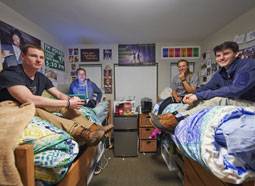 Colgate students in their dorm with a fridge