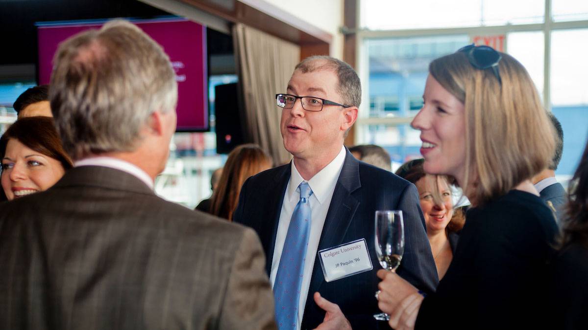 Alumni socializing at off-campus Colgate event