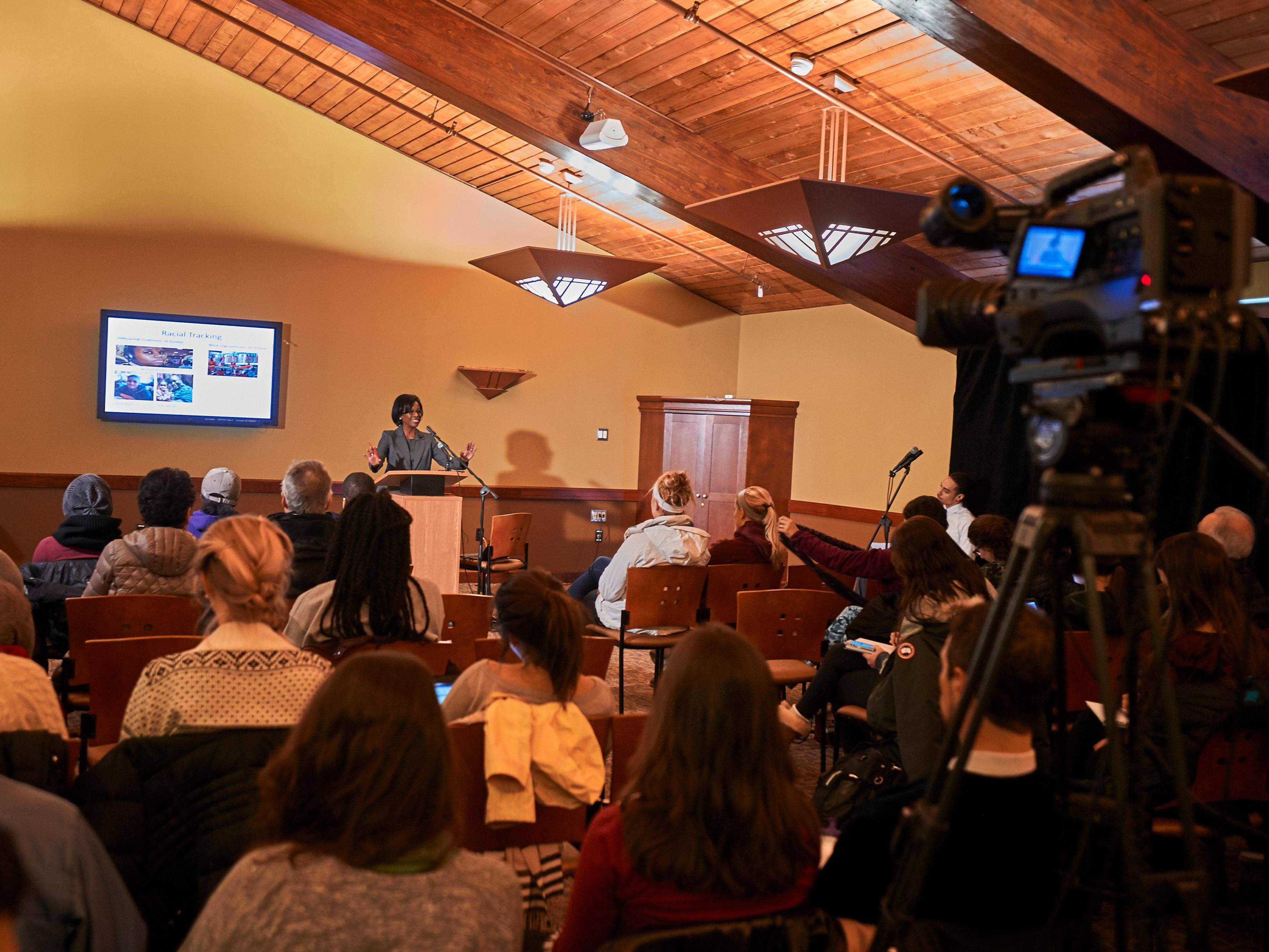 Small group attending an indoor presentation.