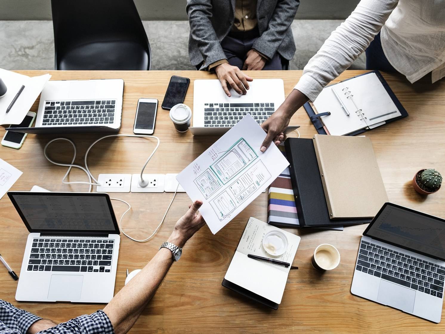 Picture of people working together in a office setting.