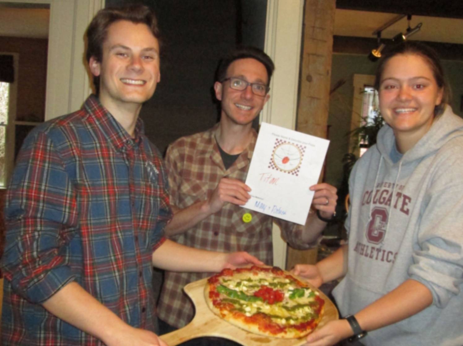 Students & professor show their geology-themed pizza