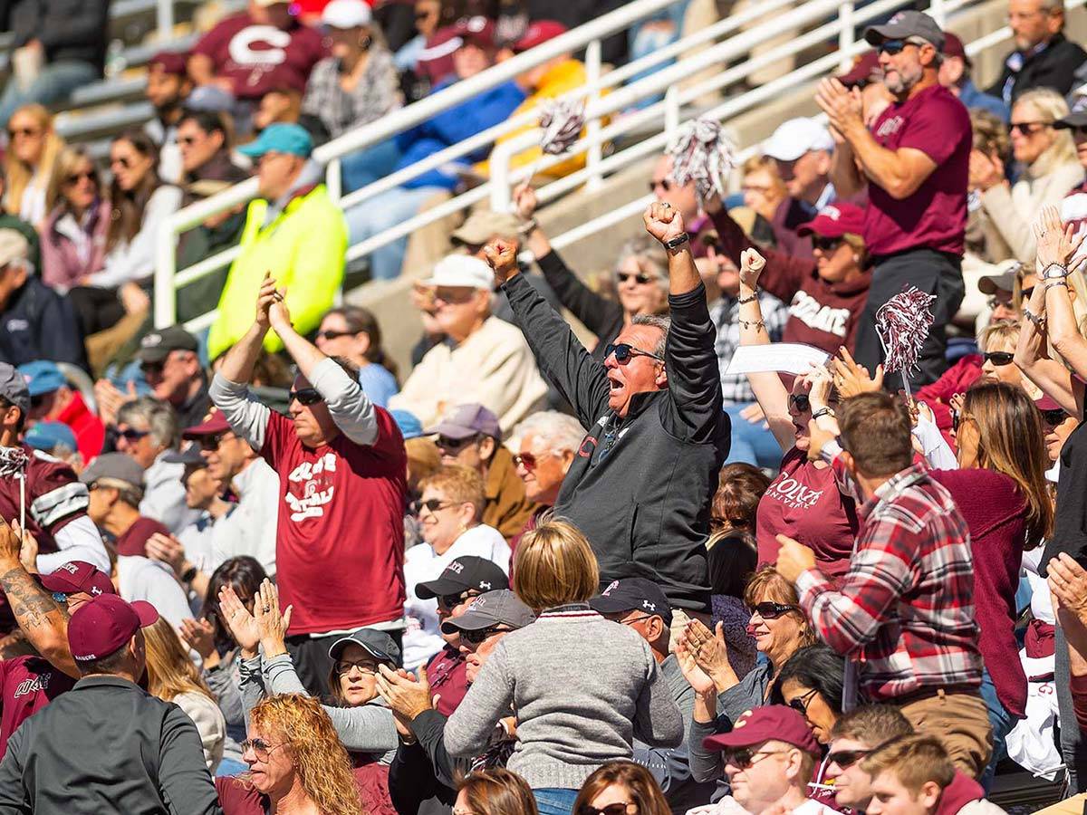 Fans cheer in the stands at Colgate's Homecoming football game