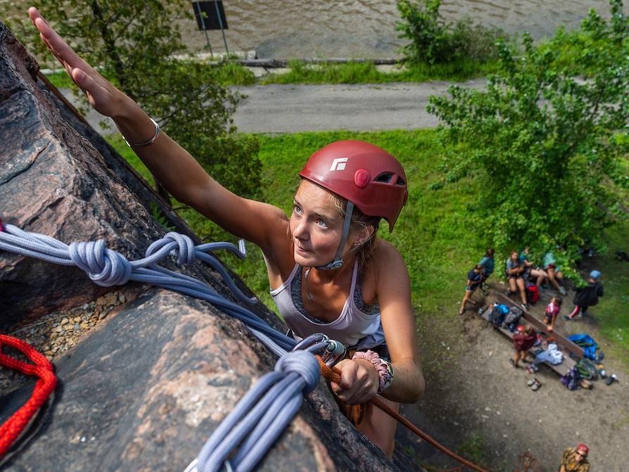 Students with Colgate University Outdoor Education climb a rock wall on Moss Island in Little Falls, N.Y., August 22, 2019.