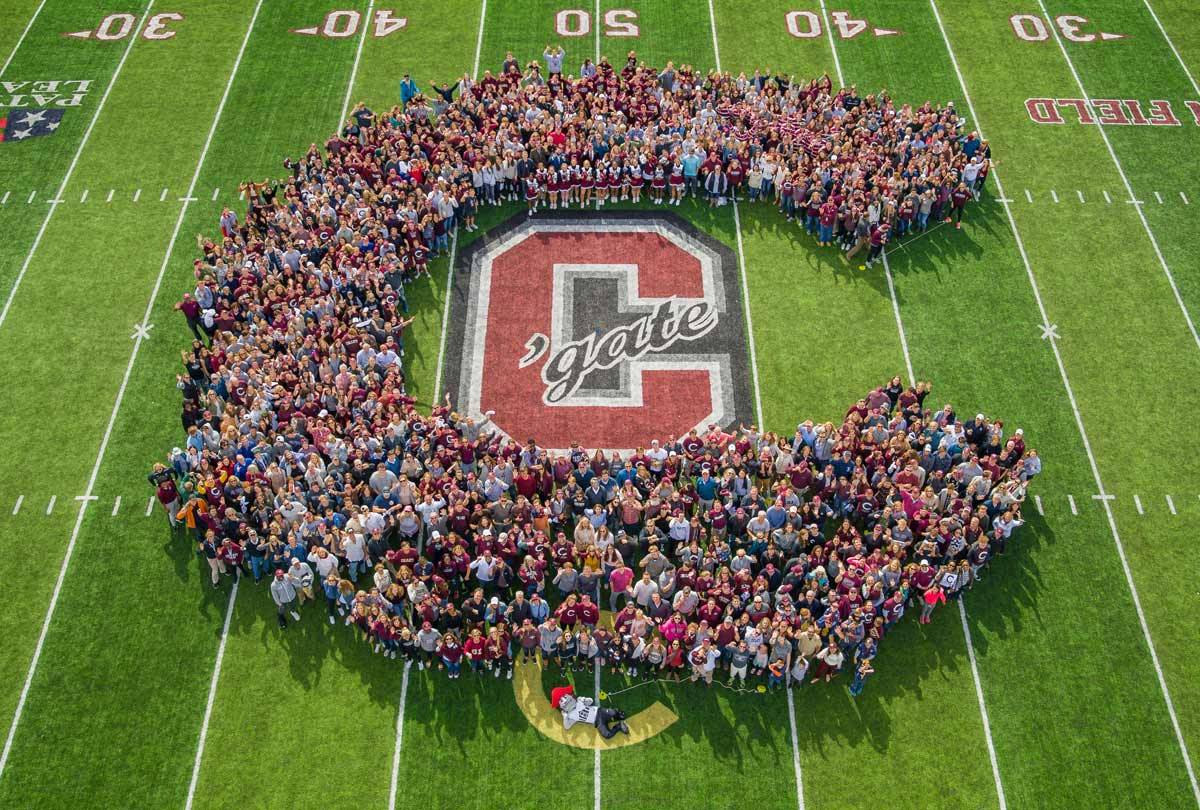 The Colgate community forming a human C on the football field.