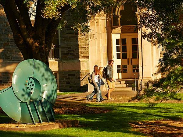 Students walking on the Academic Quad past McGregory Hall