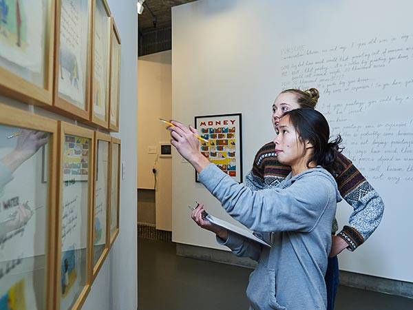 Two students observe an installation at the Picker Art Gallery