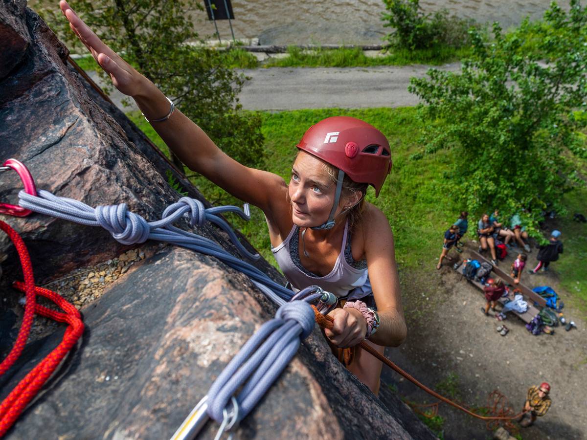 A student rock climbing.