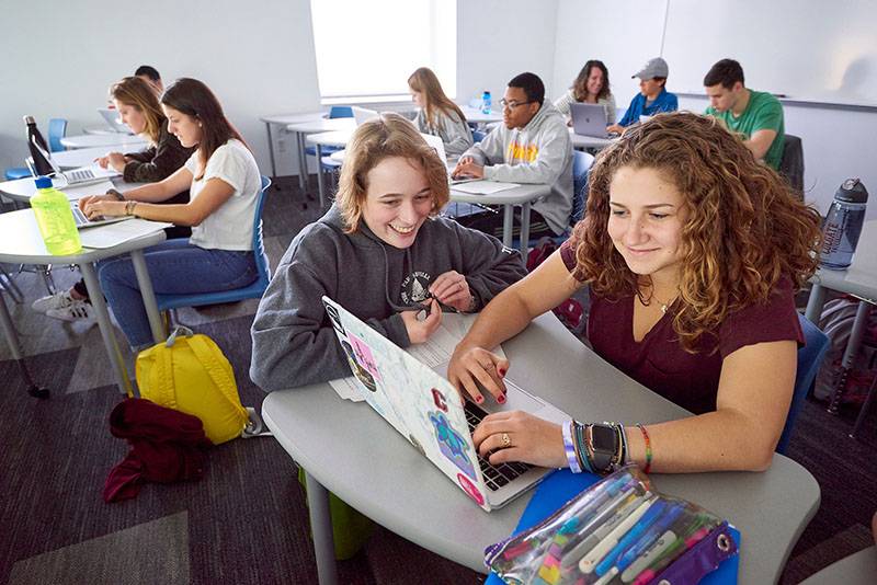 A group of students in a classroom studying independently