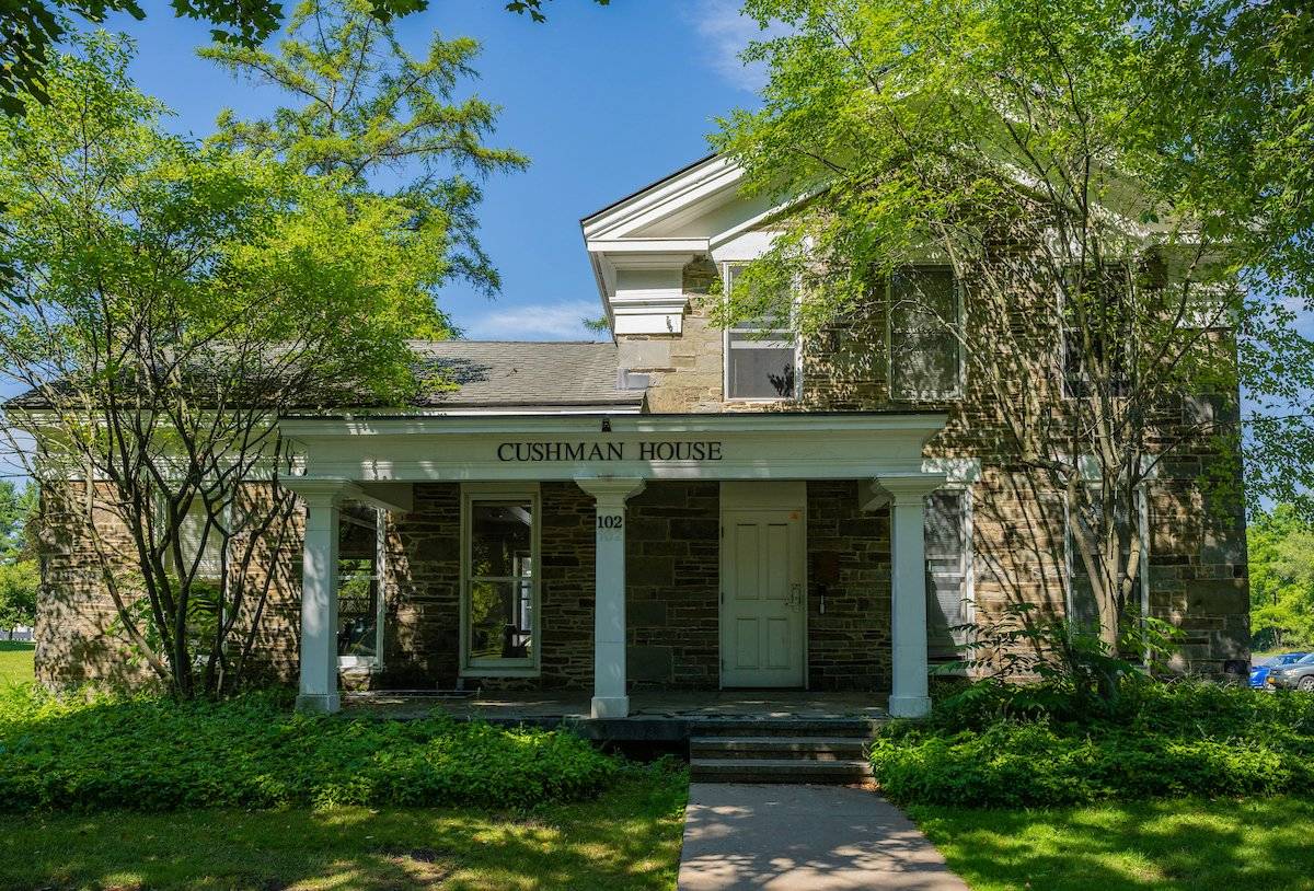 Sun dappled Cushman House during the summer
