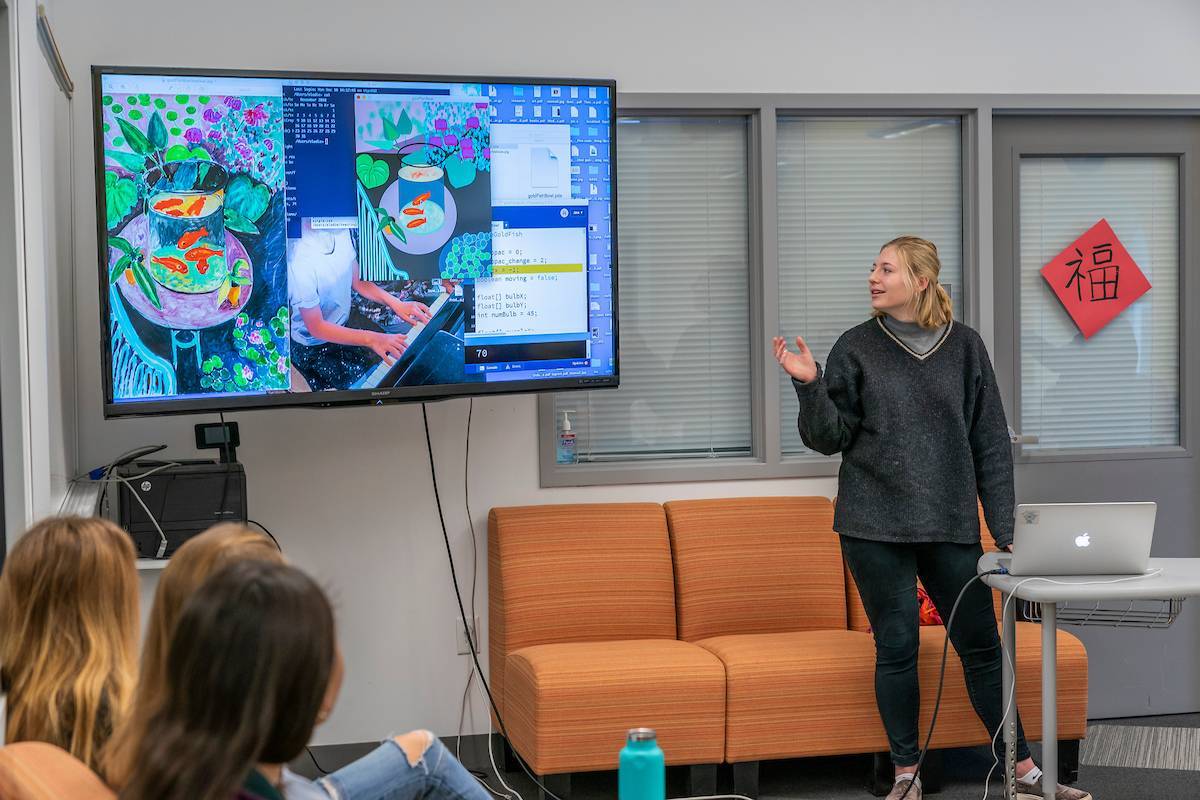 Student presenting work on digital screen